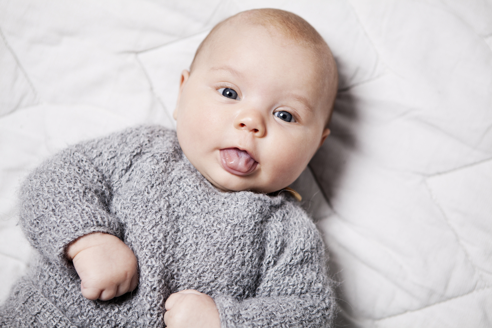 Close,Up,Of,A,3,Month,Old,Baby,Sticking,Her